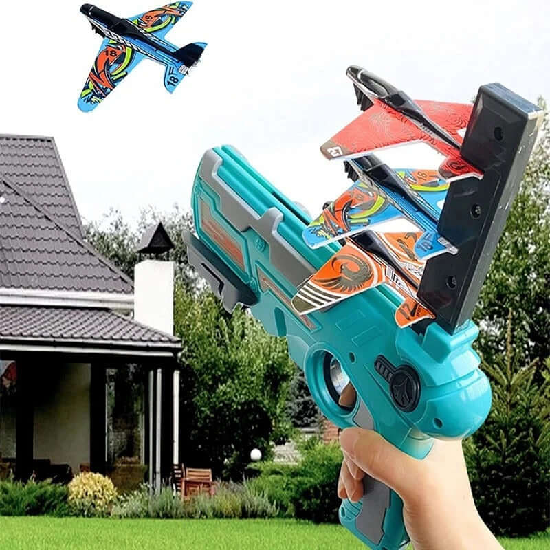 Child holding an airplane launcher blaster toy, launching colorful foam glider planes outdoors.