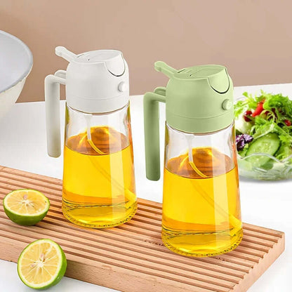 2-in-1 glass oil dispenser and sprayer in white and green with oil and lime on a wooden cutting board.
