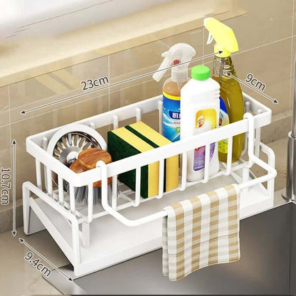 Adjustable sink storage and drainage rack with sponges, cleaning supplies, and a dishcloth for kitchen organization.